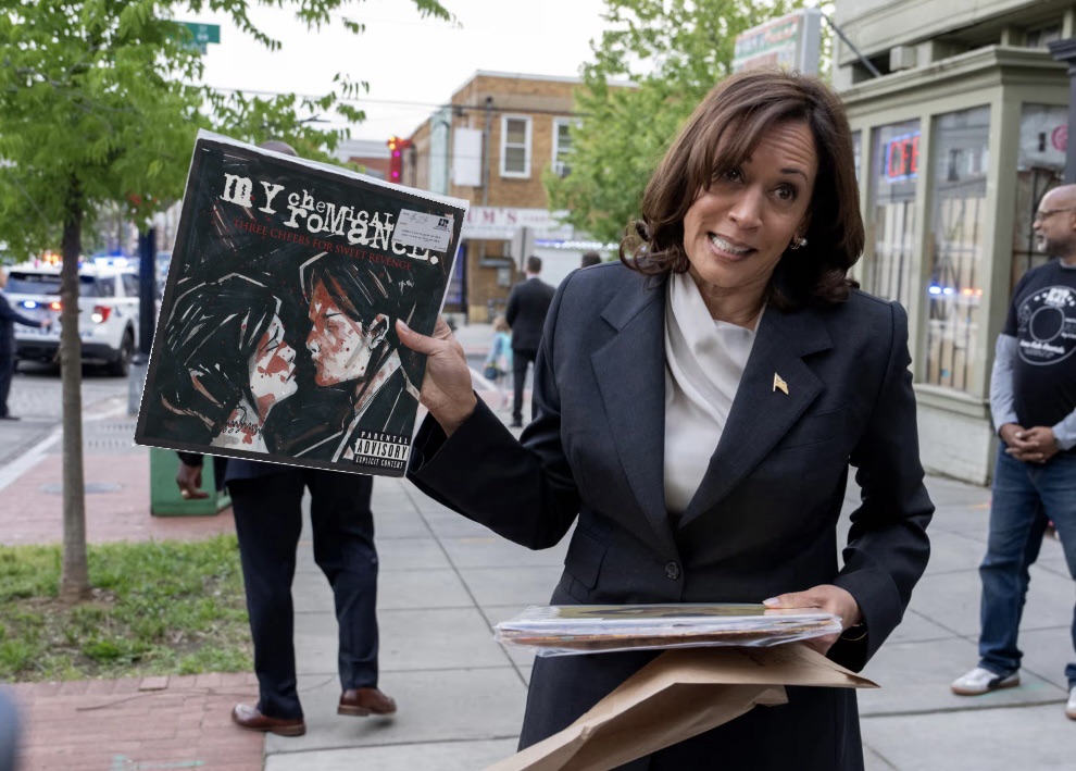 an altered image showing Presidential candidate Harris holding vinyl record in one hand and holding up Three Cheers for Sweet Revenge in the other. The original image showed Harris holding up a plain white album cover - perhaps the White album - and the my chemical romance cover has been digitally layered into the image